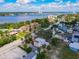 Stunning aerial shot showcases colorful homes nestled near the waterfront with lush trees under a cloudy sky at 20 N Halifax Ave, Daytona Beach, FL 32118