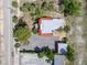 Aerial view of the property with a detached garage and surrounding foliage at 20 N Halifax Ave, Daytona Beach, FL 32118