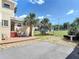 Backyard with deck, outdoor seating, and mature palm trees at 20 N Halifax Ave, Daytona Beach, FL 32118