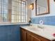 Bathroom featuring blue tiled walls and a well-lit vanity area at 20 N Halifax Ave, Daytona Beach, FL 32118