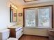 Bathroom features a vanity, mirror, and window providing natural light at 20 N Halifax Ave, Daytona Beach, FL 32118