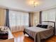 Bright bedroom with hardwood floors, large windows with sheer curtains, and chandelier lighting at 20 N Halifax Ave, Daytona Beach, FL 32118
