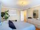 Bedroom with hardwood floors, neutral wall colors, chandelier lighting, and a large window at 20 N Halifax Ave, Daytona Beach, FL 32118