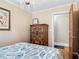 Bedroom with wooden cabinet, door to bathroom, and a decorative chandelier at 20 N Halifax Ave, Daytona Beach, FL 32118