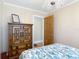 Bedroom with wooden cabinet, door to bathroom, and a decorative chandelier at 20 N Halifax Ave, Daytona Beach, FL 32118