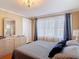 A naturally lit bedroom with hardwood floors, a modern dresser and mirror, and neutral color palette at 20 N Halifax Ave, Daytona Beach, FL 32118