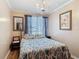 Cozy bedroom featuring a decorative chandelier and a patterned bedspread at 20 N Halifax Ave, Daytona Beach, FL 32118