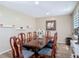 Traditional dining room with a glossy wood table, seating for eight, and wood-look flooring at 20 N Halifax Ave, Daytona Beach, FL 32118