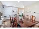 A dining room featuring a large table, seating for eight, wood floors, and a large shelving unit at 20 N Halifax Ave, Daytona Beach, FL 32118