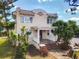 Charming two-story home featuring a Spanish tile roof, stucco exterior, and inviting front porch with brick steps at 20 N Halifax Ave, Daytona Beach, FL 32118