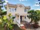 Charming two-story home featuring a Spanish tile roof, stucco exterior, and inviting front porch with brick steps at 20 N Halifax Ave, Daytona Beach, FL 32118