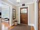 Home foyer featuring a hardwood floor, a vintage wood door and adjacent seating area at 20 N Halifax Ave, Daytona Beach, FL 32118