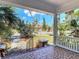 View from the covered front porch showcasing a mosaic tile floor and views of the surrounding greenery at 20 N Halifax Ave, Daytona Beach, FL 32118