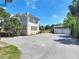 Spacious paved driveway and detached two-car garage, with the home's exterior in the background at 20 N Halifax Ave, Daytona Beach, FL 32118