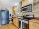 Efficient kitchen with stainless steel appliances, wooden cabinets, and ample counter space at 20 N Halifax Ave, Daytona Beach, FL 32118