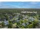 An aerial view highlights the home's location in a neighborhood near a commercial district at 2009 Brian Ave, South Daytona, FL 32119