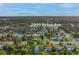 An aerial view shows the property in a verdant neighborhood close to a main road at 2009 Brian Ave, South Daytona, FL 32119
