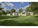Spacious backyard with lush green lawn, white fence and a shed, perfect for outdoor activities at 2009 Brian Ave, South Daytona, FL 32119
