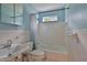 Blue bathroom features tiled shower-tub combination with white fixtures and tiled walls at 2009 Brian Ave, South Daytona, FL 32119