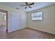Bedroom with wood-look flooring, ceiling fan, window, and double closets at 2009 Brian Ave, South Daytona, FL 32119