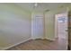 Bedroom with a ceiling fan, wood-look flooring, window, and nearby bathroom at 2009 Brian Ave, South Daytona, FL 32119