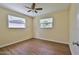Bedroom featuring wood-look floors, ceiling fan, and two windows at 2009 Brian Ave, South Daytona, FL 32119