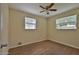 Bedroom with a ceiling fan, two windows, and wood-look flooring at 2009 Brian Ave, South Daytona, FL 32119