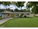 Charming single-story home with a covered carport and a well-maintained lawn at 2009 Brian Ave, South Daytona, FL 32119