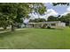 Beautifully landscaped front yard featuring lush green grass and a charming single-story home at 2009 Brian Ave, South Daytona, FL 32119