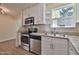 Stylish kitchen featuring stainless steel appliances, granite countertops, and white cabinets at 2009 Brian Ave, South Daytona, FL 32119