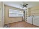 A laundry room with washer, dryer, storage shelves, and a ceiling fan at 2009 Brian Ave, South Daytona, FL 32119