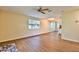Bright living room boasts new flooring, a ceiling fan, and a large window at 2009 Brian Ave, South Daytona, FL 32119