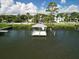 Overhead shot of the covered boat dock next to a house nestled among lush greenery along a tranquil waterway at 206 S Riverside Dr, Edgewater, FL 32132