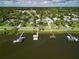 Aerial view showcasing the property's proximity to the water, including boat docks and lush surroundings at 206 S Riverside Dr, Edgewater, FL 32132