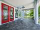 Spacious balcony with views featuring tile flooring, red french doors, and a spiral staircase at 206 S Riverside Dr, Edgewater, FL 32132