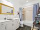 Bright bathroom features a vanity with mirror, shower with tub, and tiled floor at 206 S Riverside Dr, Edgewater, FL 32132