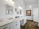 Bathroom with a white double vanity, tiled floors and separate door to the water closet at 206 S Riverside Dr, Edgewater, FL 32132