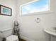 Neat half bathroom with open window, featuring modern fixtures at 206 S Riverside Dr, Edgewater, FL 32132