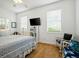 Comfortable bedroom showcasing windows, a white ceiling fan, and hardwood floors at 206 S Riverside Dr, Edgewater, FL 32132