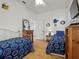 Bright bedroom featuring hardwood floors, two beds with blue pattern, and closet space at 206 S Riverside Dr, Edgewater, FL 32132
