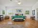 Large bedroom with bright natural light with windows surrounding and hardwood floors at 206 S Riverside Dr, Edgewater, FL 32132