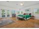 Bright bedroom with hardwood floors, multiple windows, and comfortable seating at 206 S Riverside Dr, Edgewater, FL 32132