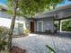 Spacious carport with elegant stonework, offering shade and access to a beautifully landscaped area at 206 S Riverside Dr, Edgewater, FL 32132