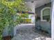 Spacious brick paver parking area under the carport with plants and pots, adding to the home's curb appeal at 206 S Riverside Dr, Edgewater, FL 32132