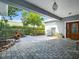 Welcoming courtyard entrance with beautiful stonework, creating an inviting outdoor living space at 206 S Riverside Dr, Edgewater, FL 32132