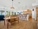 Spacious dining area with a wooden table and chairs, connecting to the kitchen and living room at 206 S Riverside Dr, Edgewater, FL 32132