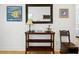 Tastefully decorated hallway featuring a mirror, console table, and chair against a light wall at 206 S Riverside Dr, Edgewater, FL 32132