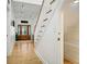 Elegant foyer showcasing a hardwood floor, a staircase, and a decorative glass door at 206 S Riverside Dr, Edgewater, FL 32132