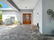 Inviting front entrance featuring a gorgeous wood door and stone-look pavers at 206 S Riverside Dr, Edgewater, FL 32132