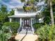 Charming two-story home with colorful tiled staircase and lush landscaping, offering curb appeal and inviting entrance at 206 S Riverside Dr, Edgewater, FL 32132